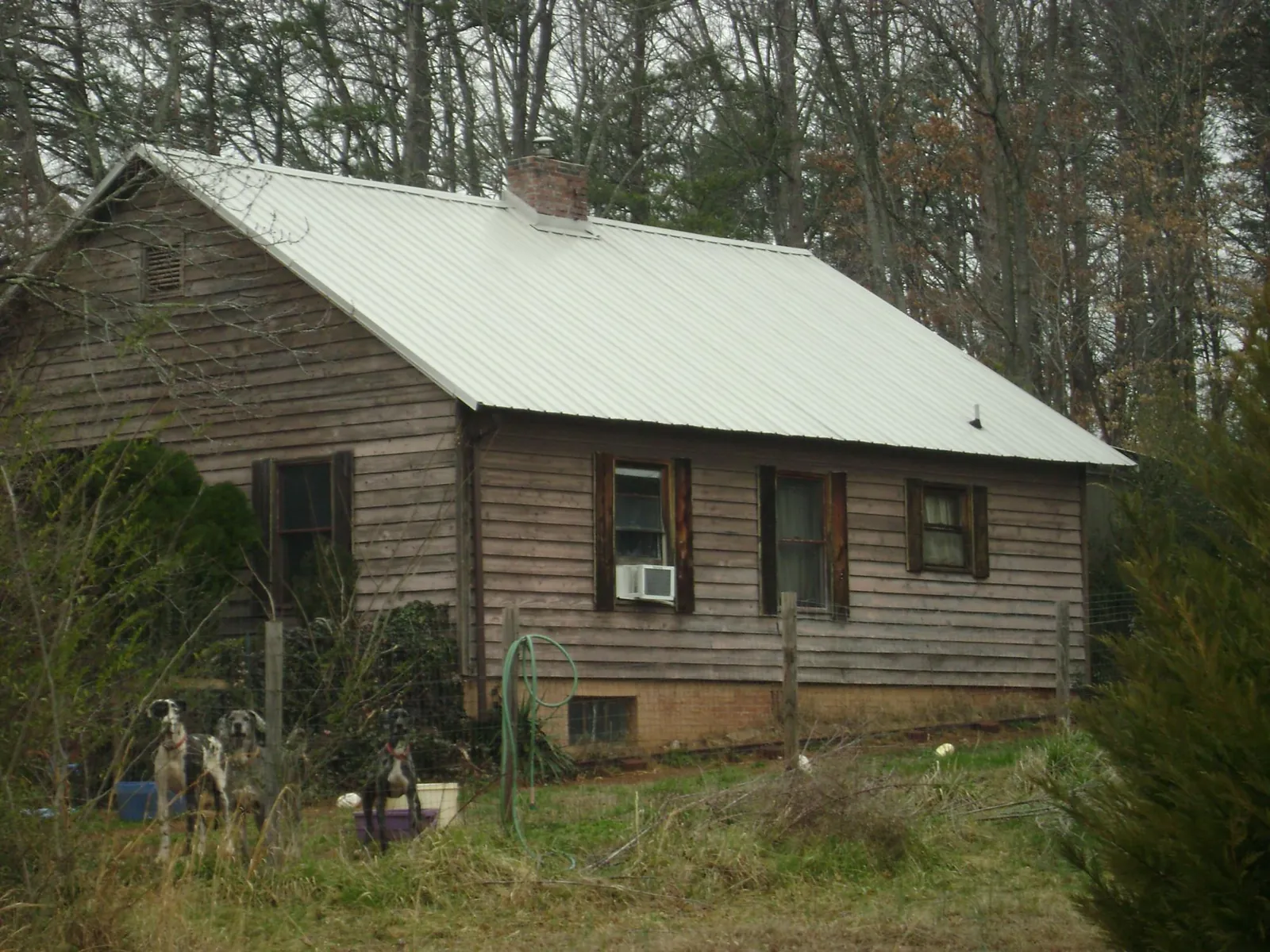 White metal roof on an old wood sided farmhouse, from a Asphalt Shingle Roof Repair job in Lansford